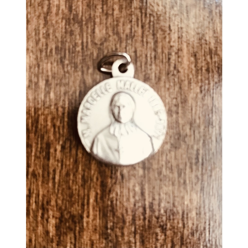Sainte Marcelle Mallet original relic in a medallion that opens up showing a piece of brown clothing