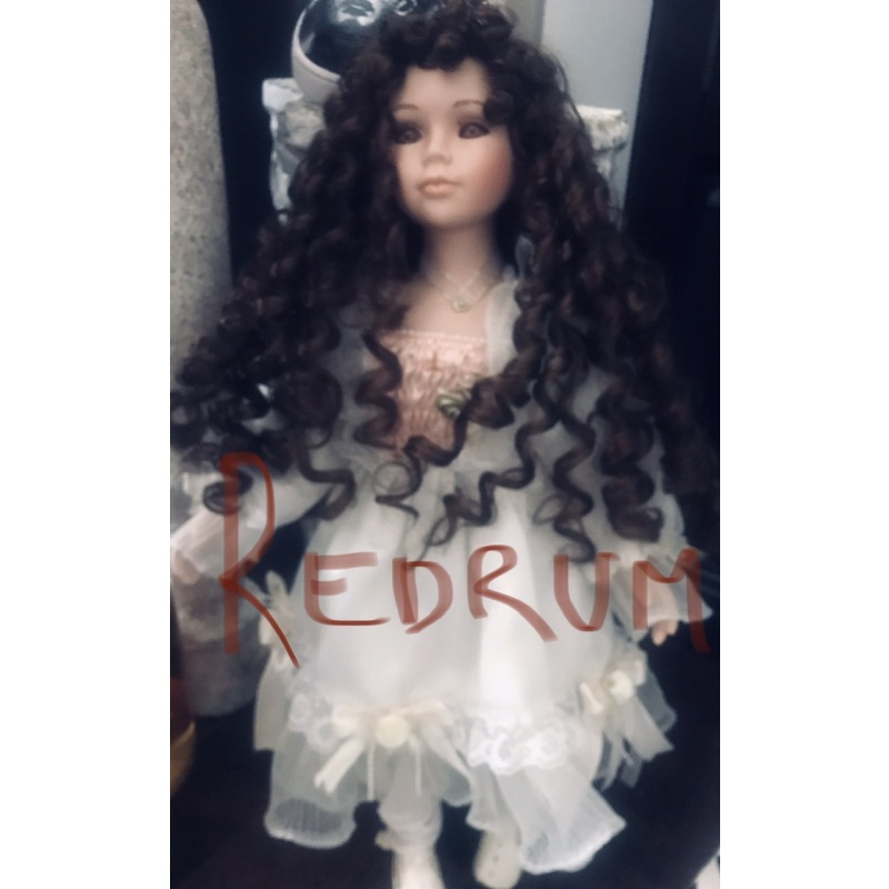 Satanic porcelain doll geogeous piece 21 inches in size fully dressed with necklace and inverted cross